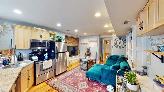 a living room with fireplace furniture and a flat screen tv