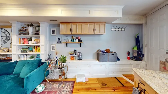 a room with furniture and a kitchen view