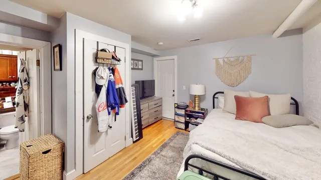 a bedroom with a bed and a mirror
