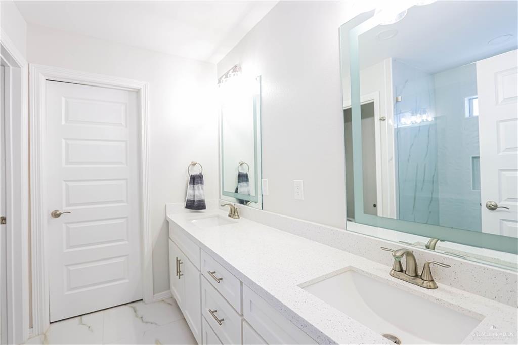 823 Whitewing Street Alamo, TX 78516 - Photo 9 of 15 a bathroom with a sink and a mirror
