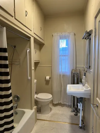 a bathroom with a sink a toilet and tub