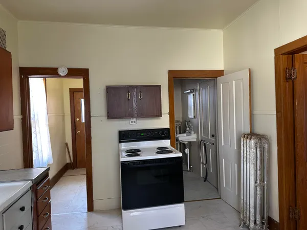 a view of a refrigerator in kitchen and livingroom