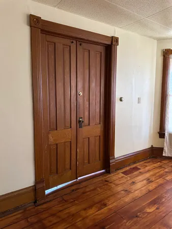 an empty room with wooden floor