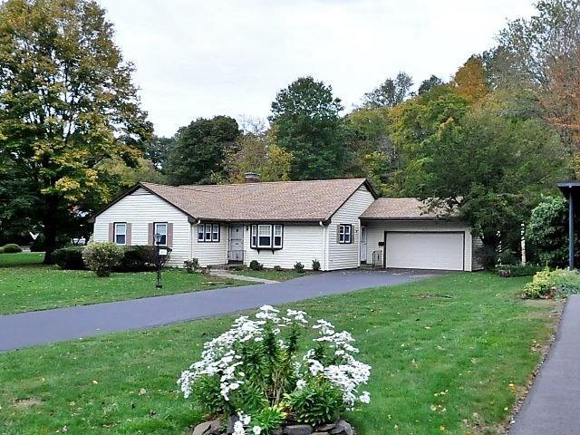 81 Pape Road New Britain, CT 06053 - Photo 1 of 1 a front view of a house with a garden and trees