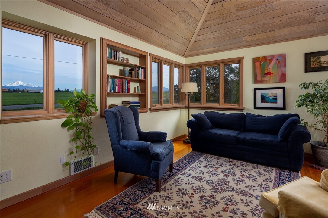 6481 Noon Road Everson, WA 98247 - Photo 11 of 25 a living room with furniture a bookshelf and a large window