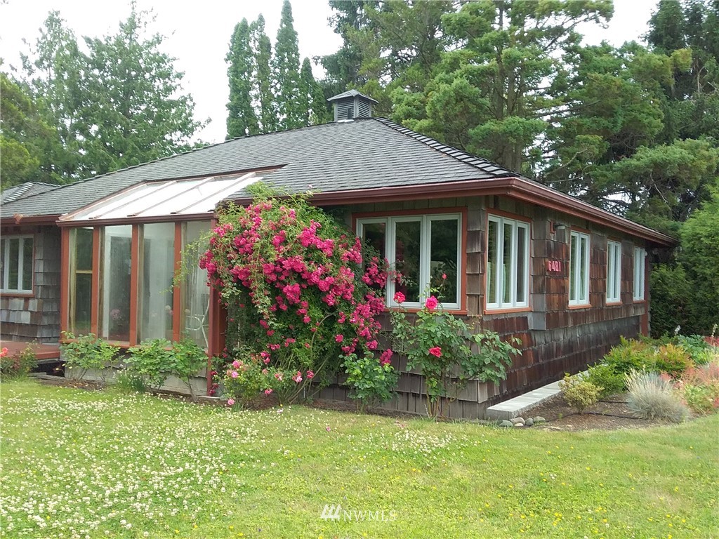 6481 Noon Road Everson, WA 98247 - Photo 7 of 25 a view of a white house with a large garden and large trees