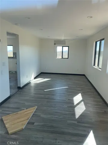 a view of a room with wooden floor