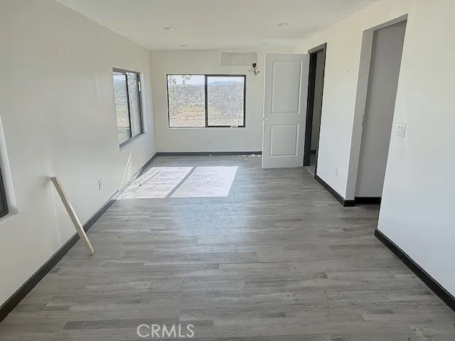a white toilet sitting next to a white cabinet