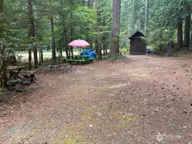 a view of a house with a yard and sitting area