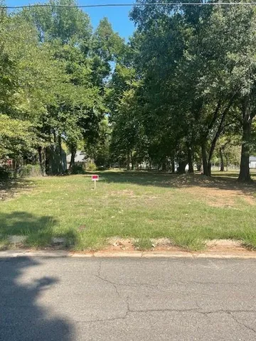 a view of outdoor space with garden and trees