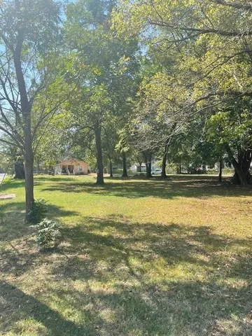 a view of a swimming pool and a yard