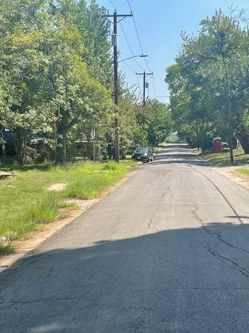 a view of a yard with potted plants