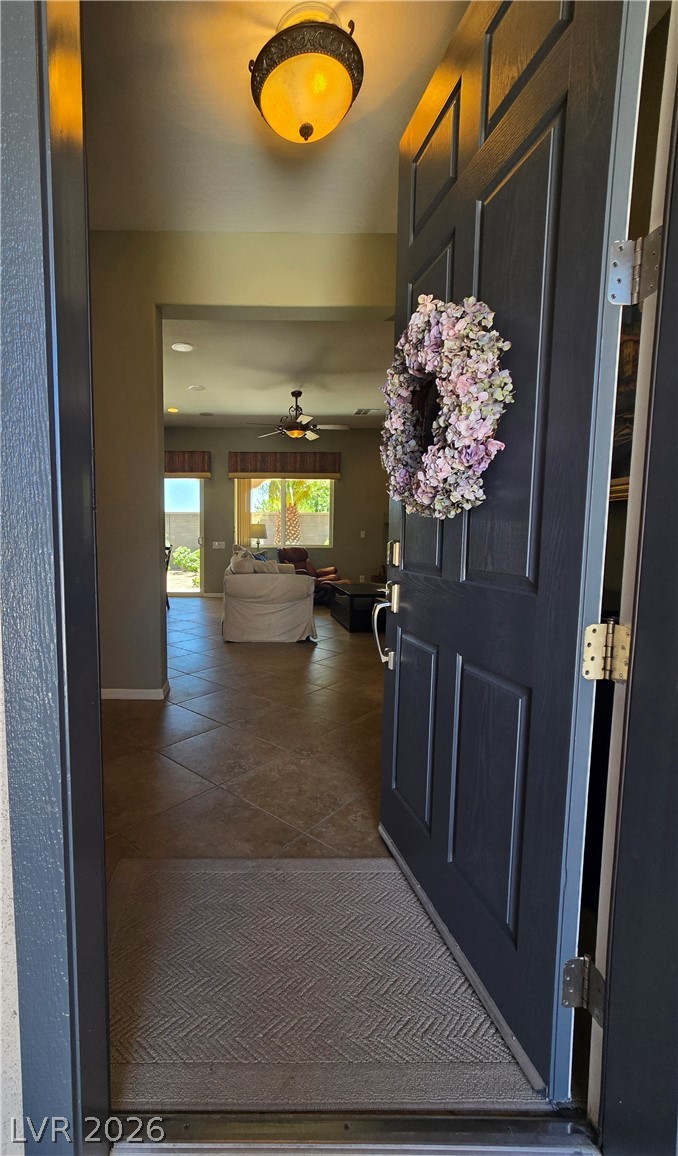 2567 Dirleton Place Henderson, NV 89044 - Photo 6 of 67 Enter into a naturally illuminated living area featuring tiled floors and an inviting ceiling fan.