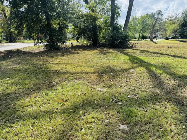 a swimming pool with trees in the background