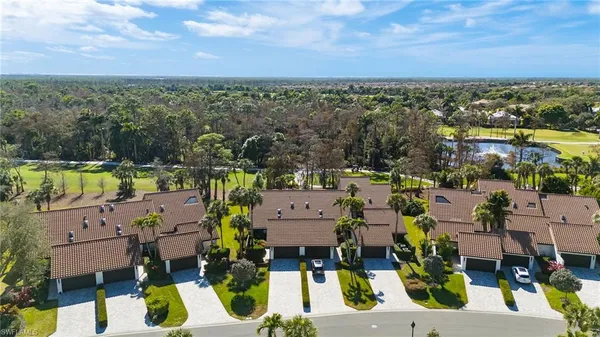 an aerial view of residential houses with outdoor space and ocean view