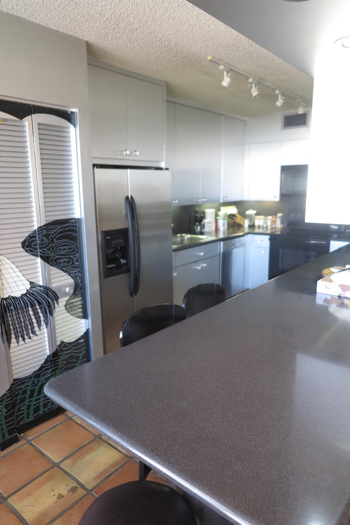 7186 Promenade Drive, Unit 801 Boca Raton, FL 33433 - Photo 7 of 21 a kitchen with stainless steel appliances kitchen island granite countertop a refrigerator a stove and a sink with wooden floor