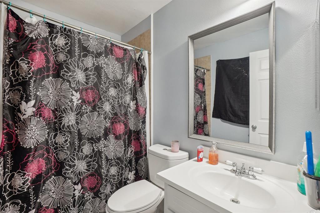 3601 Chime Street Irving, TX 75062 - Photo 13 of 17 a bathroom with a sink toilet and shower curtain