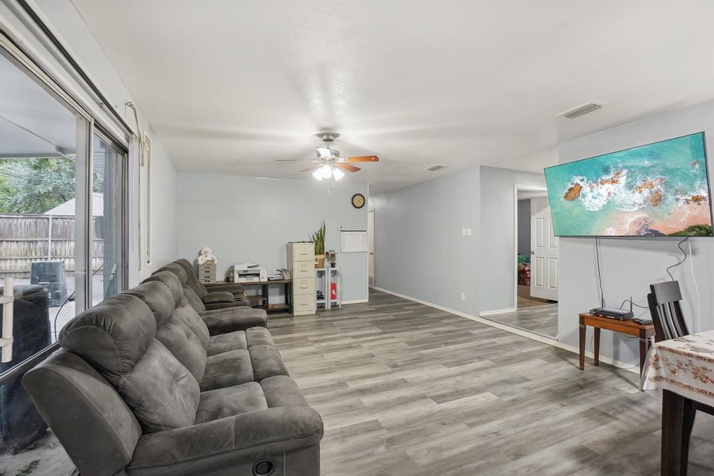 3601 Chime Street Irving, TX 75062 - Photo 6 of 17 a living room with furniture a dining table and a flat screen tv