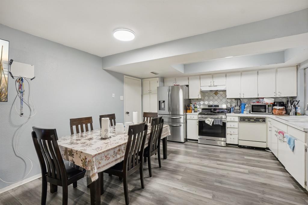 3601 Chime Street Irving, TX 75062 - Photo 7 of 17 a kitchen with stainless steel appliances a table chairs microwave and refrigerator
