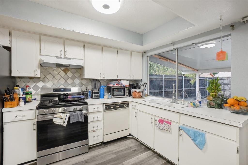 3601 Chime Street Irving, TX 75062 - Photo 8 of 17 a kitchen with a stove a sink and a refrigerator