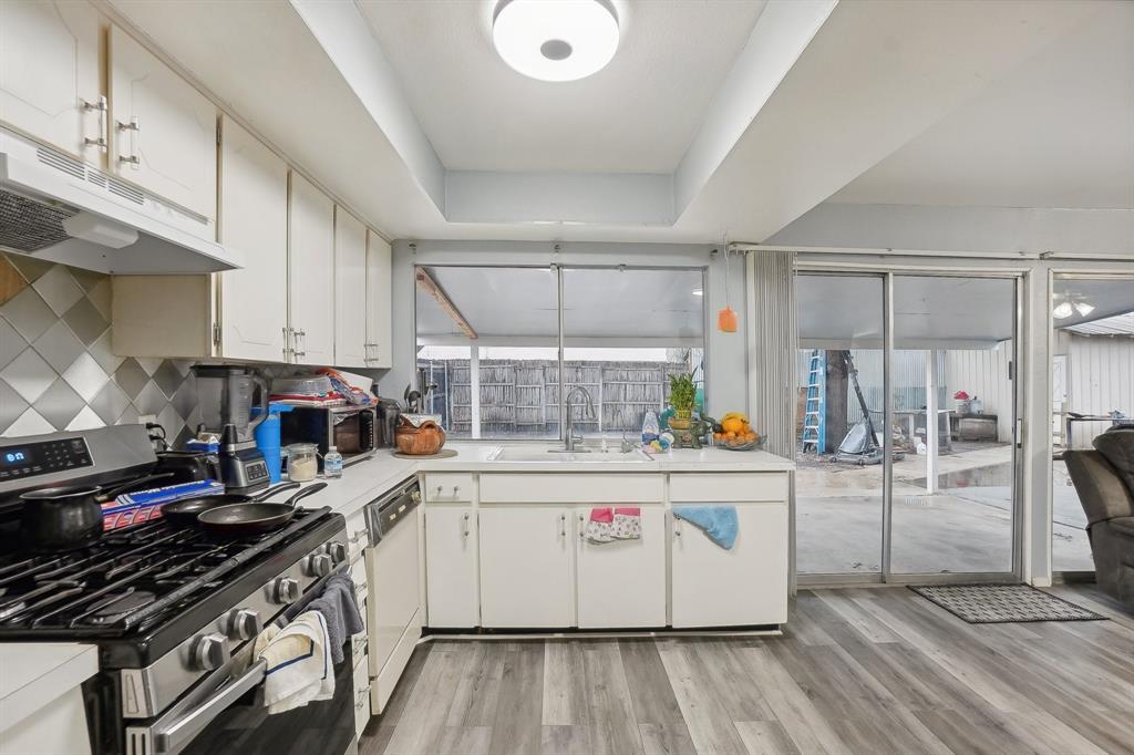 3601 Chime Street Irving, TX 75062 - Photo 9 of 17 a kitchen with a stove and wooden cabinets
