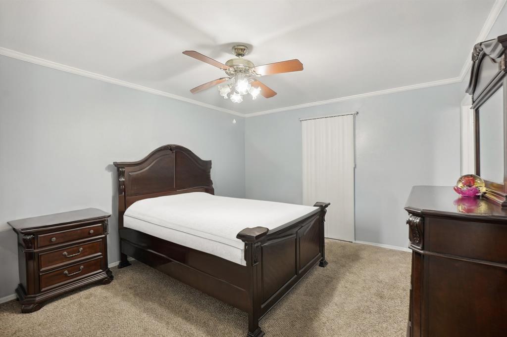 3601 Chime Street Irving, TX 75062 - Photo 10 of 17 a bedroom with a bed and a chandelier