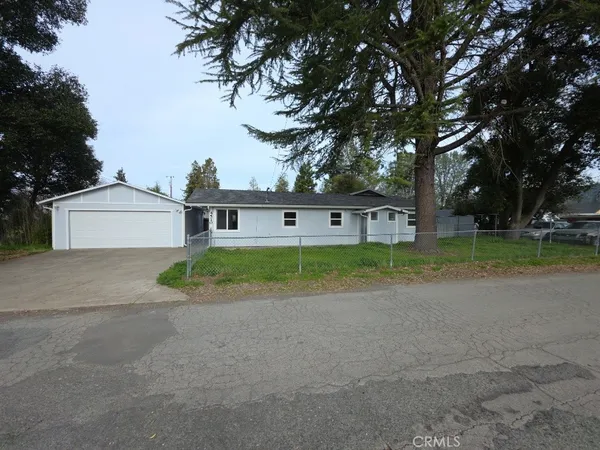 a view of a house with a yard and garage