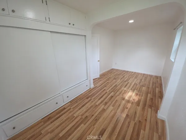 a view of room with wooden floor