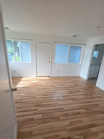 a view of room with window and wooden floor