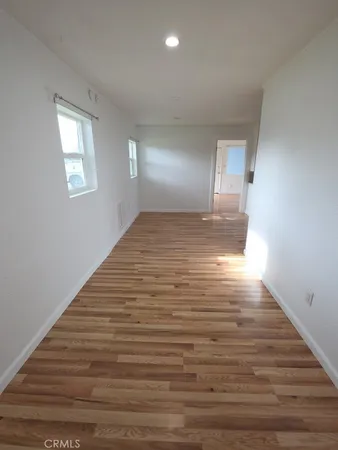 a view of a room with wooden floor