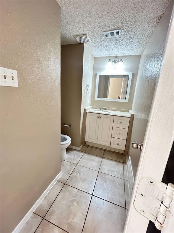 2818 South Fielder Road Arlington, TX 76015 - Photo 11 of 31 a bathroom with a sink a toilet and a mirror
