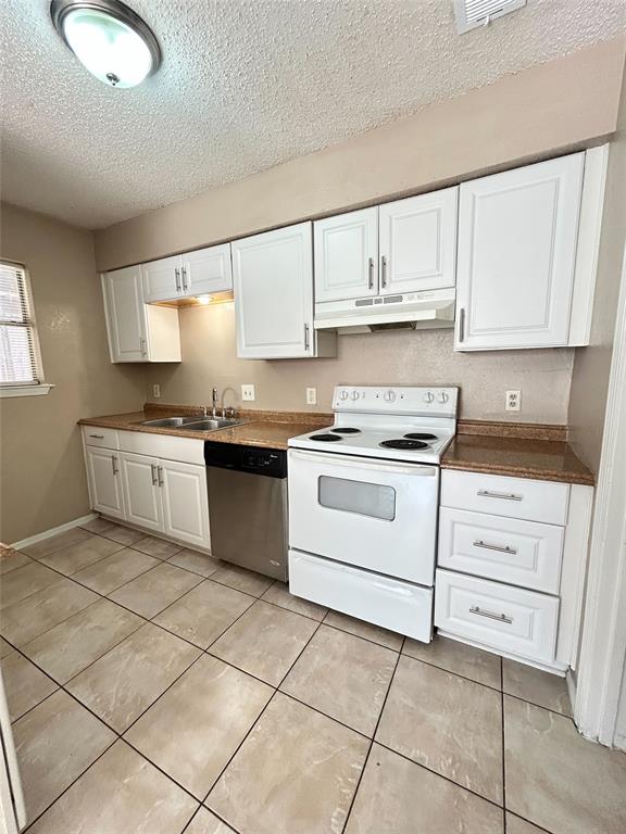 2818 South Fielder Road Arlington, TX 76015 - Photo 15 of 31 a kitchen with a stove top oven sink and cabinets