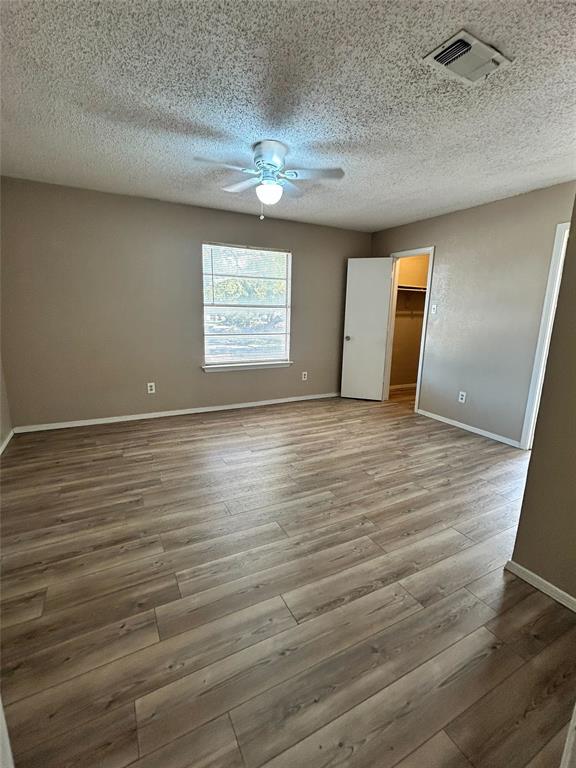 2818 South Fielder Road Arlington, TX 76015 - Photo 18 of 31 an empty room with wooden floor and windows