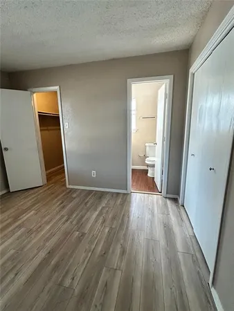 an empty room with wooden floor and a window