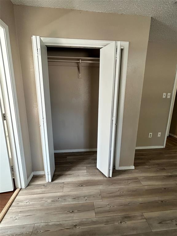 2818 South Fielder Road Arlington, TX 76015 - Photo 21 of 31 an empty room with wooden floor and a window