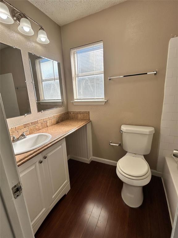 2818 South Fielder Road Arlington, TX 76015 - Photo 22 of 31 a bathroom with a toilet sink and mirror