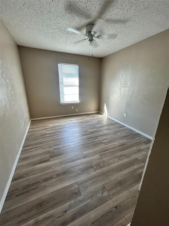 2818 South Fielder Road Arlington, TX 76015 - Photo 25 of 31 wooden floor in an empty room with a window