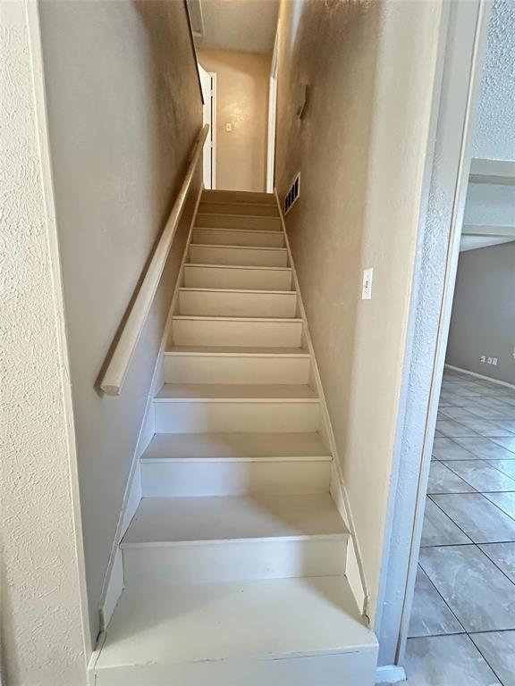 2818 South Fielder Road Arlington, TX 76015 - Photo 5 of 31 a view of staircase with white walls and white door