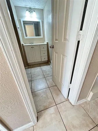 a bathroom with a sink a mirror and cabinets