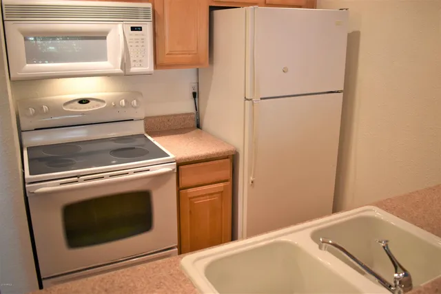 a view of a chairs and table in the balcony