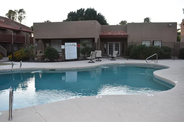 a view of a house with pool and sitting area