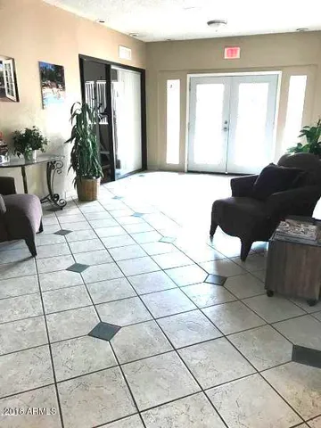a view of an empty room with a kitchen