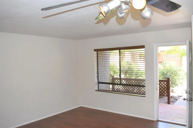 a view of a room that has a window and a fan