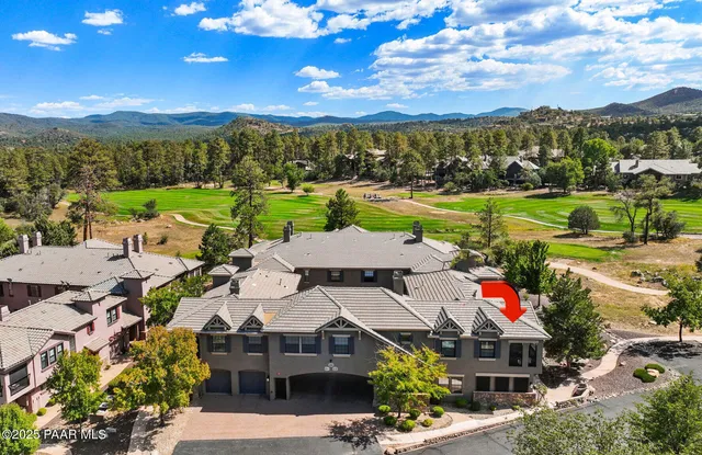 a view of a city with lots of houses ocean and mountain view in back