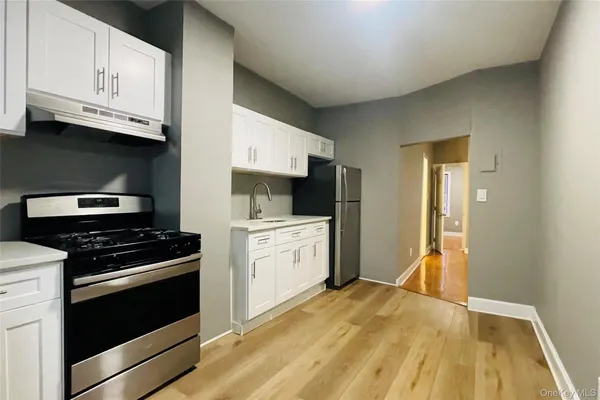 a kitchen with a stove and a refrigerator