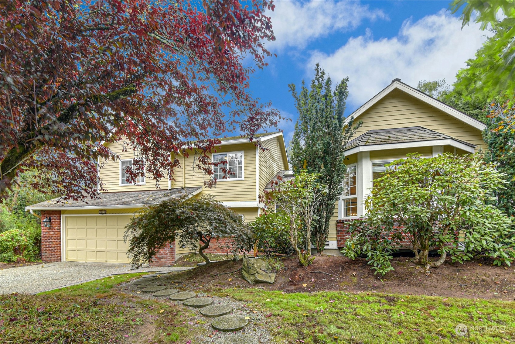 a view of a house with a yard and plants