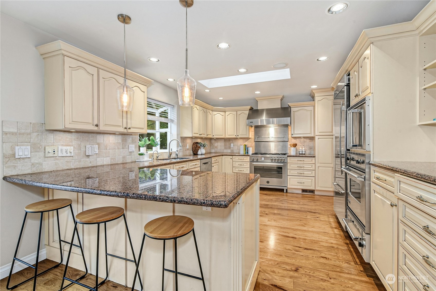 24040 Brier Road Brier, WA 98036 - Photo 12 of 37 a kitchen with stainless steel appliances granite countertop a refrigerator a sink and a stove
