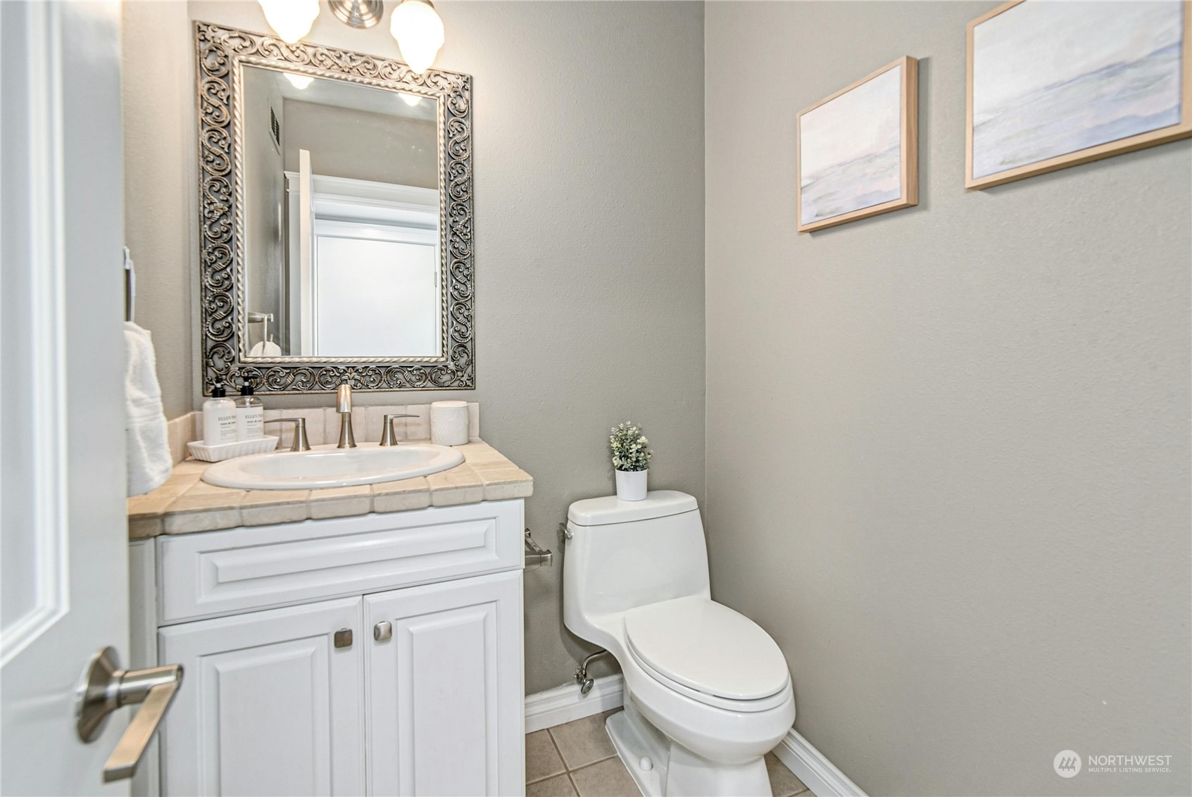24040 Brier Road Brier, WA 98036 - Photo 27 of 37 a bathroom with a granite countertop toilet a sink and a mirror