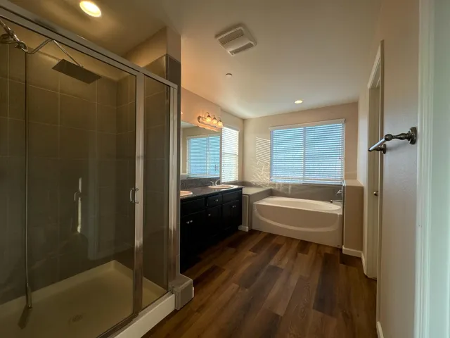 a bathroom with a bathtub and a shower