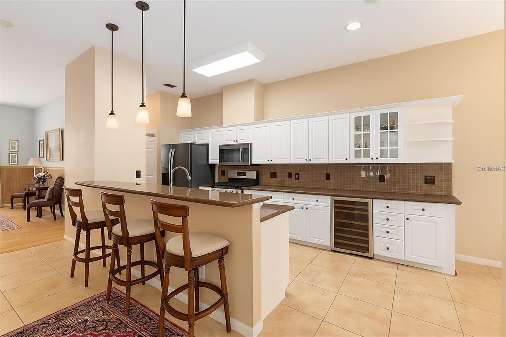 10160 Southwest 48th Place Gainesville, FL 32608 - Photo 12 of 68 a kitchen with stainless steel appliances granite countertop a stove a sink and a refrigerator